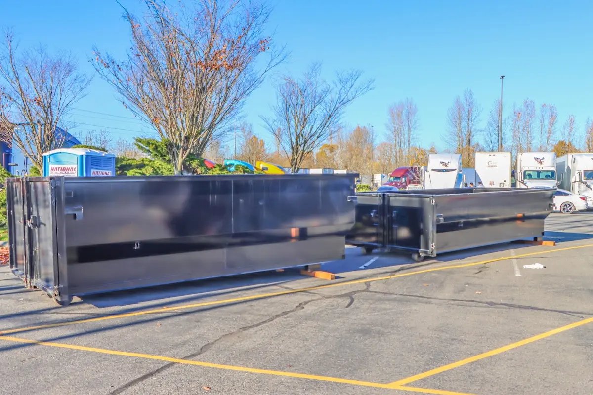 Professional dumpster rental service with roll-off container on residential driveway in Brunswick